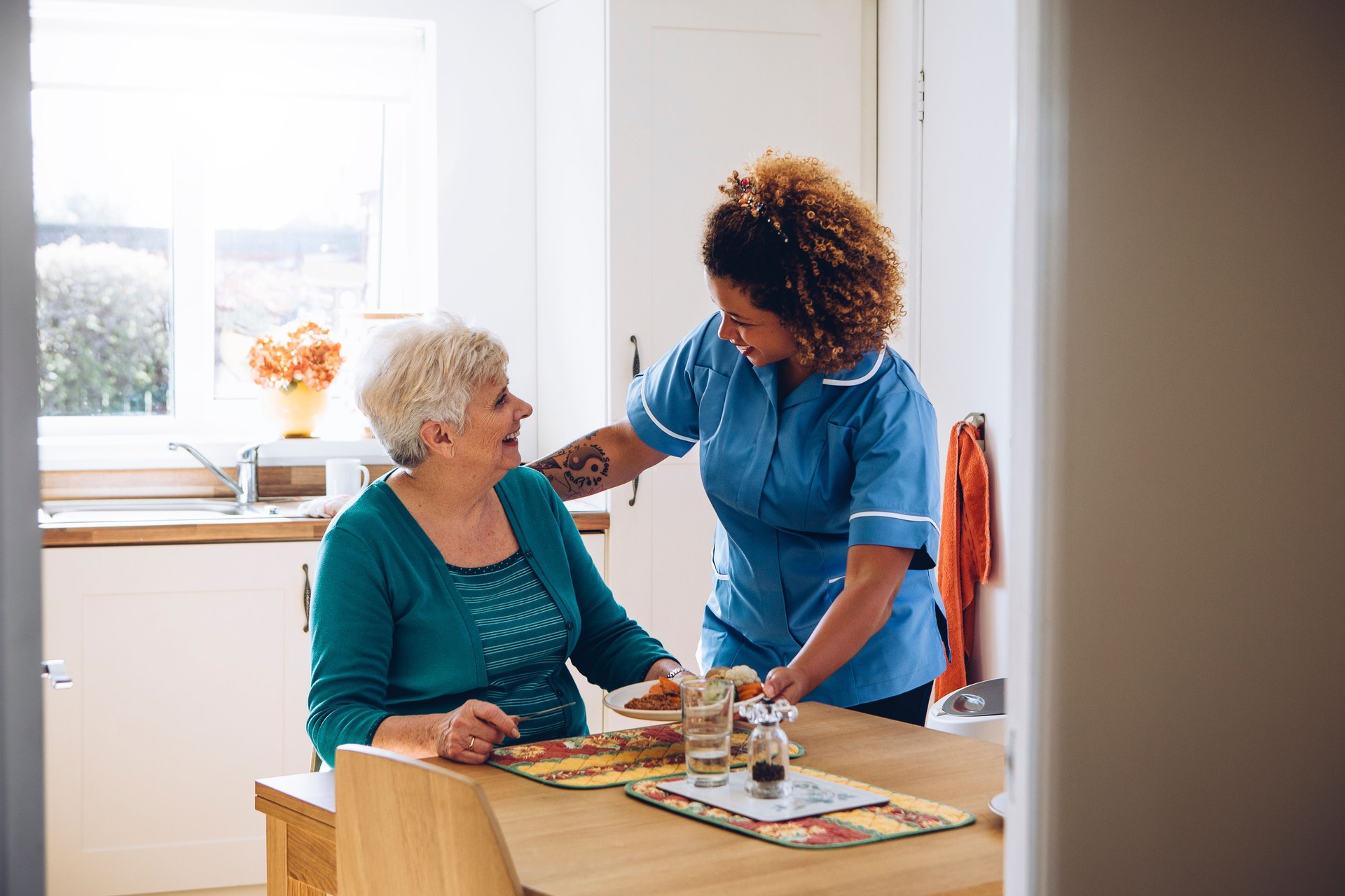in-home caregiver assisting elderly woman with daily activities and meals in Punta Gorda Florida