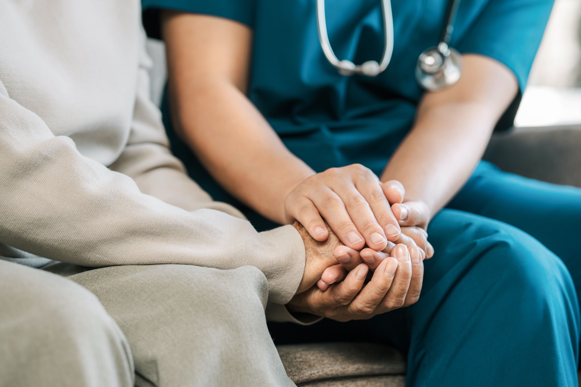nurse holding hands with senior to provide compassionate home care in Port Charlotte Florida